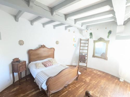 a bedroom with a bed and a ladder and a mirror at La Tour in Béziers