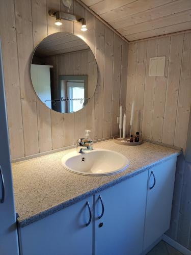 a bathroom with a sink and a mirror at Fantastic Spa Holiday Home in Hemmet