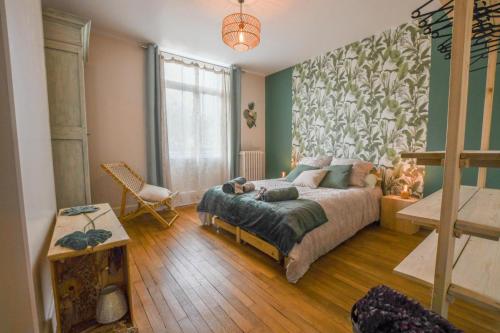 a bedroom with a bed and a large window at Les halles du temps in Bar-sur-Seine