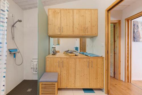 a bathroom with a wooden cabinet in a room at Gite Le Koto in Thorigny