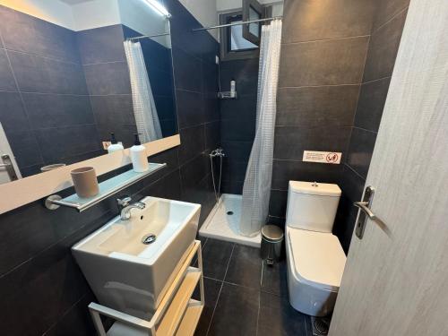 a bathroom with a sink and a toilet at nafsea in Afitos