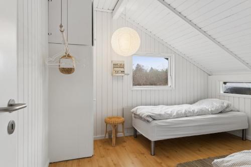 a bedroom with a bed and a window at Charming Cottage Near The Water in Holbæk