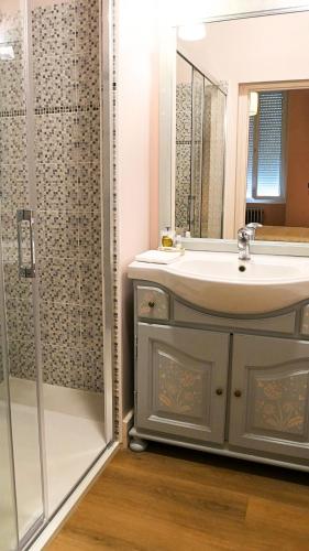 a bathroom with a sink and a shower at La Belle Chartreuse in Manciet