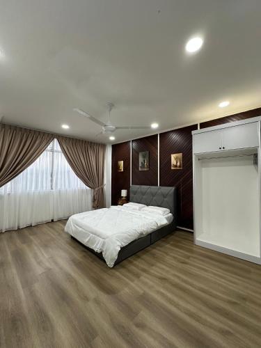 a bedroom with a large bed and a large window at RY Homestay in Tawau