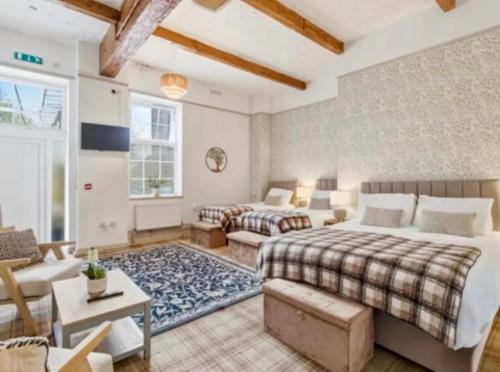 a bedroom with two beds and a living room at Blenkinsopp Castle Inn in Greenhead
