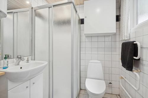 a bathroom with a shower and a toilet and a sink at Well-Designed House In Scenic Surroundings in Martofte