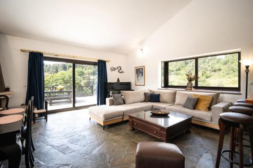 a living room with a couch and a table at Petra Kazarma in Kymi