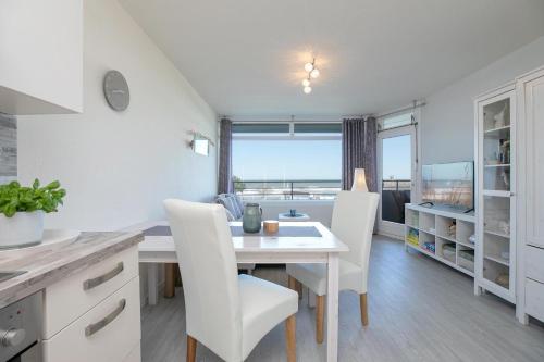 a kitchen and dining room with a table and chairs at Strandhotel Dahme TraumMeerBlick in Dahme