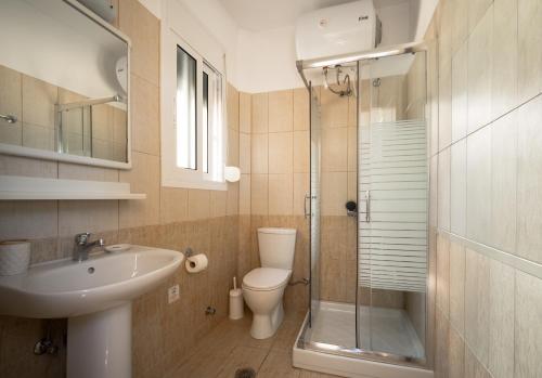 a bathroom with a toilet and a sink and a shower at Villa Renata -Pool, Large Garden & Free Parking, 2 Minutes Walk from The Beach in Barbati