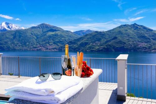 a table with towels and glasses on a balcony at Casa Laura Apt. 6 in Menaggio