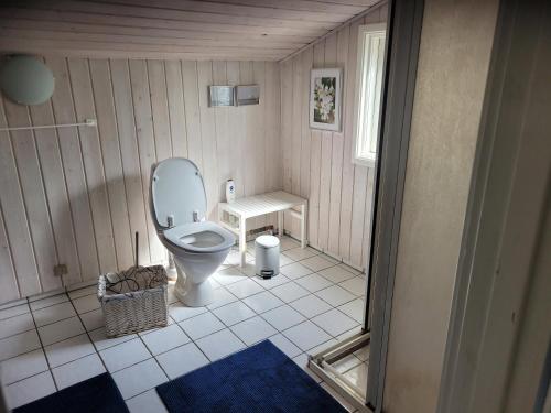a small bathroom with a toilet and a table at Natural Plot Fireplace And True West Coast in Thisted