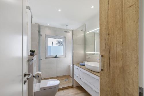 a bathroom with a white toilet and a sink at Fewo-Taunus-Panoramablick in Königstein im Taunus