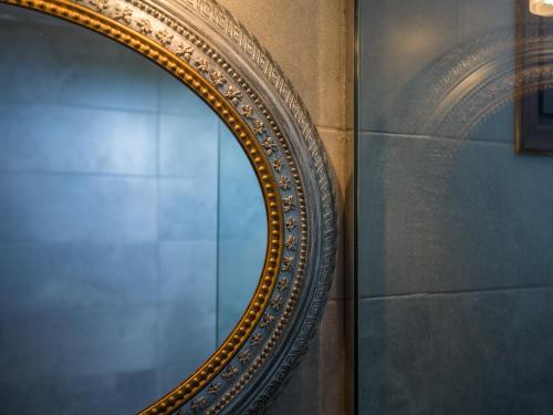 a gold mirror on a wall in a room at Anna Traditional Apartments in Kamari