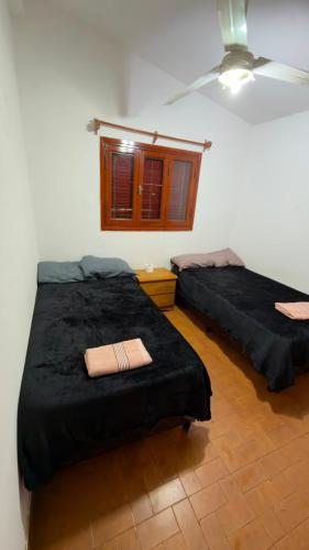 a bedroom with two beds and a window at Dulce descanso 3 Bed and Breakfast in Salta