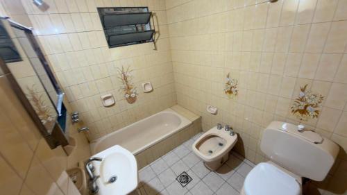 a bathroom with a toilet and a bidet and a sink at Dulce descanso 3 Bed and Breakfast in Salta