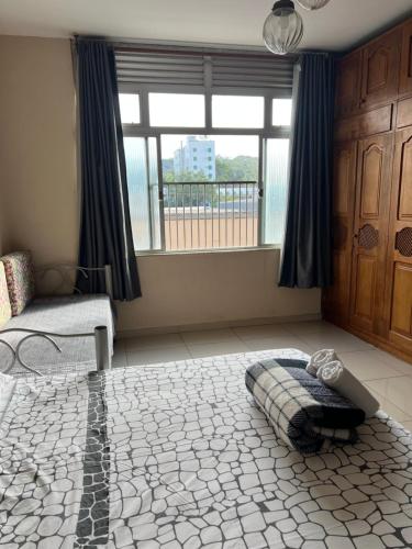a living room with a bed and a window at Suítes São Lourenço in São Lourenço