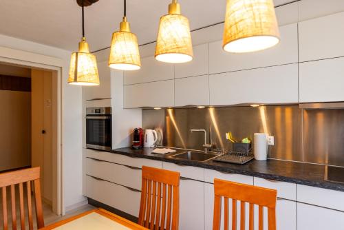 a kitchen with a counter and some lights at Hauswurz in Thun