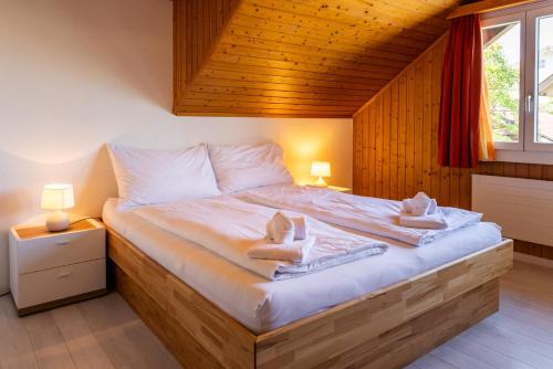 a bedroom with a large bed with towels on it at Hauswurz in Thun