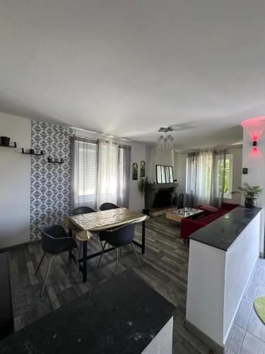 a kitchen and living room with a table and chairs at Theviennehouse in Cenon-sur-Vienne
