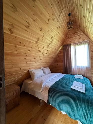 a bedroom with a bed in a log cabin at Cottage Caucasus in Ushguli