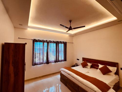 a bedroom with a bed and a ceiling fan at ramraz residency in Ayodhya