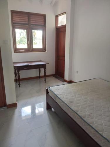 a bedroom with a bed and a piano in it at Kurana Resident in Katunayaka