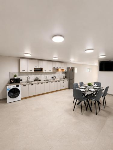 a kitchen and dining room with a table and chairs at EVURI Rooms in Uzhhorod