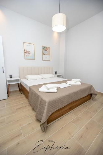 a bedroom with a bed with towels on it at Euphoria Central Living in Stavros