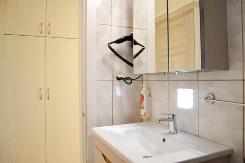 a bathroom with a sink and a mirror at Kale Otel Bodrum in Bodrum City