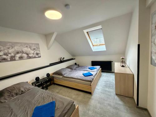 a bedroom with a bed and a dresser in it at Teplice apartments DELUXE in Teplice