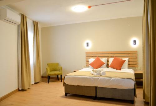 a hotel room with a bed and a chair at Kale Otel Bodrum in Bodrum City
