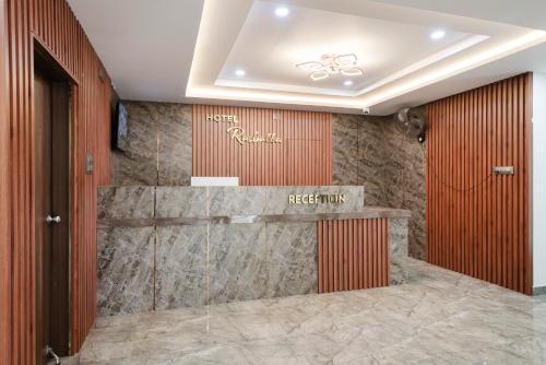 a hotel lobby with a sign on the wall at Hotel Rasballa Grand in Bhadrāchalam Road