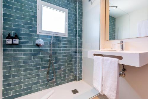 a bathroom with a shower and a sink at San Fermín by Dorobe in Benalmádena