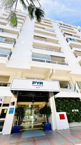 a large white building with a rsync sign in front of it at Hotel PYR, Spacious Studio with a Big Terrace in Fuengirola