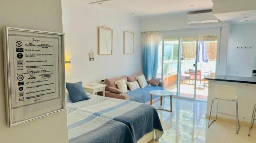 a bedroom with a bed and a living room at Hotel PYR, Spacious Studio with a Big Terrace in Fuengirola