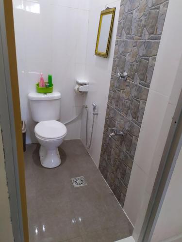 a bathroom with a toilet and a shower at Desa Besut Inn in Kampung Kuala Besut