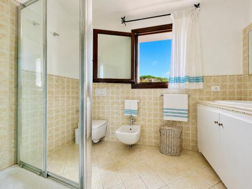 a bathroom with a shower and a toilet and a sink at Sea View Within Walking Distance of the Beach in Baja Sardinia