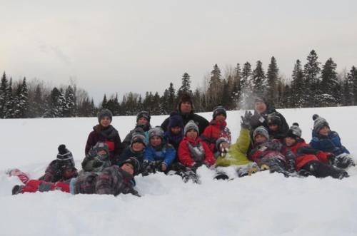 a group of people posing for a picture in the snow at Le Gîte Ambrelane in Thetford Mines