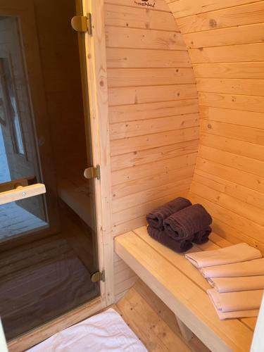a sauna with two towels on a wooden wall at Apartments Maxi in Strážné