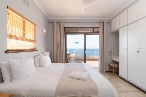 a bedroom with a bed with a view of the ocean at Chaka Terraces 10 in Ballito