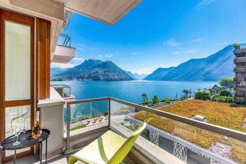 a balcony with a view of a lake and mountains at Paradiso Incanto Lake View Apartment - Happy Rentals in Paradiso