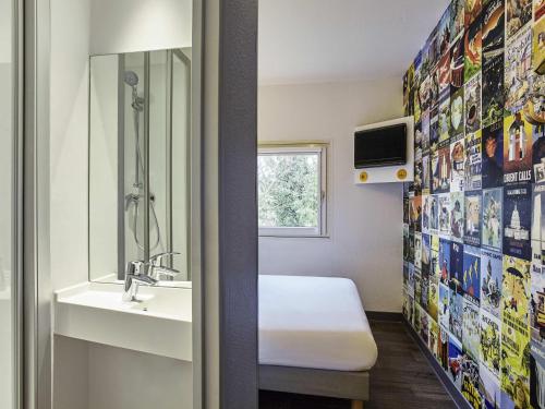 a bathroom with a sink and a shower at hotelF1 Limoges in Limoges
