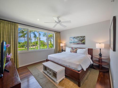 a bedroom with a bed and a large window at 3-Bed Villa 203 at Turtle Bay in Kahuku