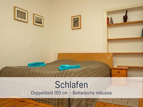 a bedroom with a bed with blue towels on it at Hof Heideland 1 in Eichholz