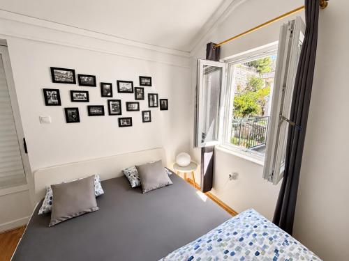 a bedroom with a bed and a window at Apartment Iris in Dubrovnik