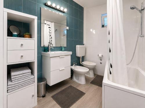 a bathroom with a toilet and a sink and a tub at Apartment Iris in Dubrovnik