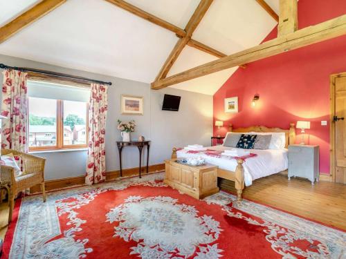 a bedroom with red walls and a bed with a red rug at 3 Bed in Appleby-in-westmorland oc-88791 in Crackenthorpe