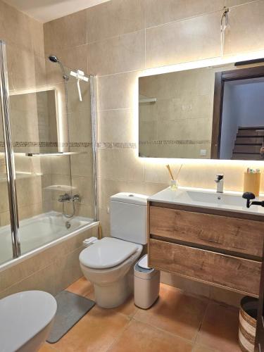 a bathroom with a toilet and a sink and a tub at Sea View Chalet - Altea Hills in Altea