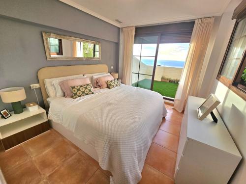 a bedroom with a bed and a large window at Sea View Chalet - Altea Hills in Altea