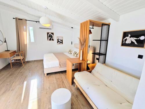 a living room with a couch and a bed at Paxos Dream House in Vlachopoulátika